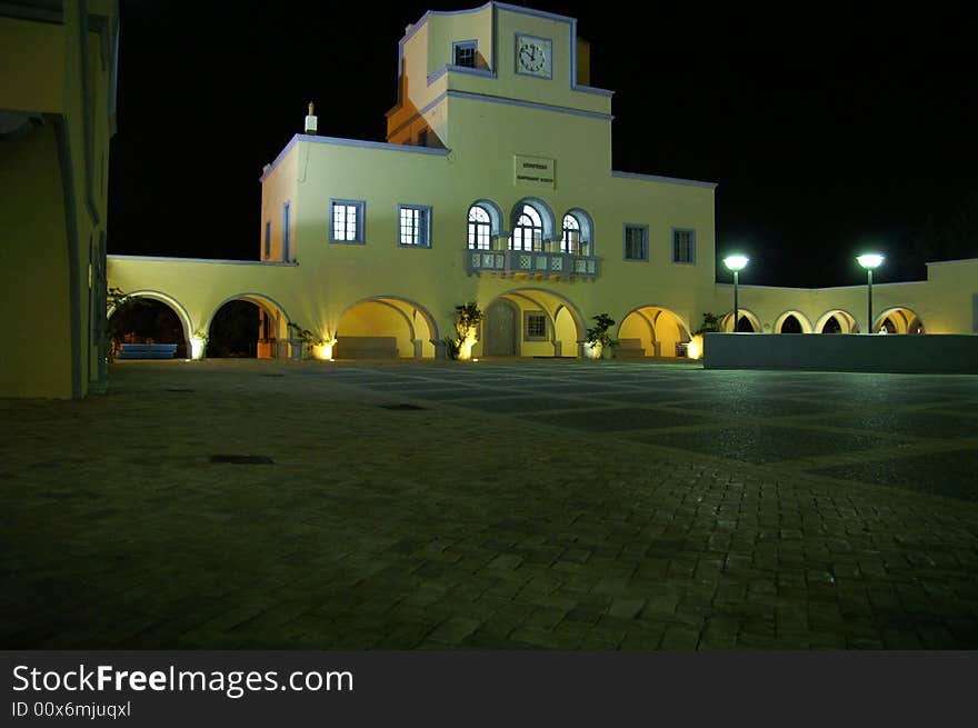 Square in front of a building that looks like the cityhall of Karpathos by night.