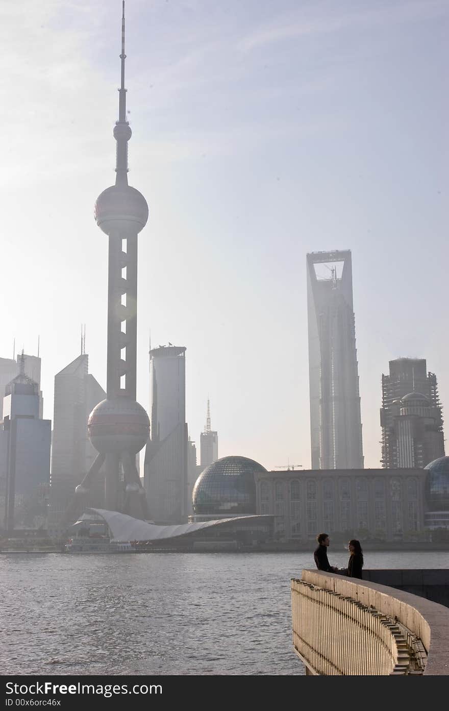 Couple talking at sunrise with Shanghai city in the background