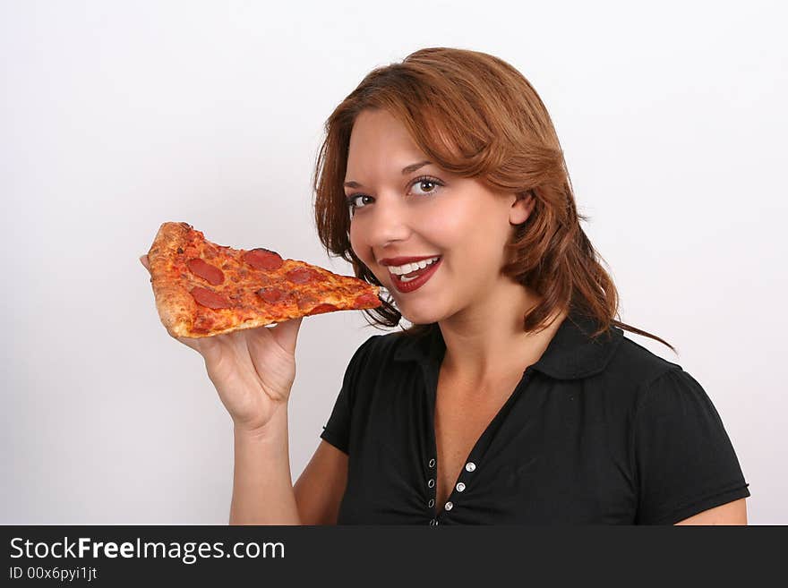 beautiful girl eating a pizza slice wearing a black t-shirt. beautiful girl eating a pizza slice wearing a black t-shirt