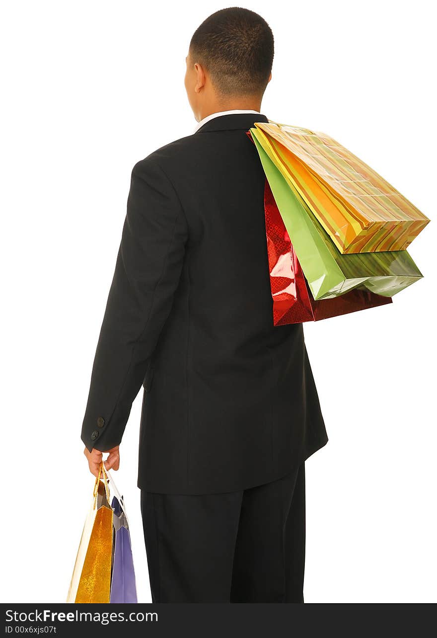 Isolated shot of male shopper from his back carrying many shopping bags. Isolated shot of male shopper from his back carrying many shopping bags