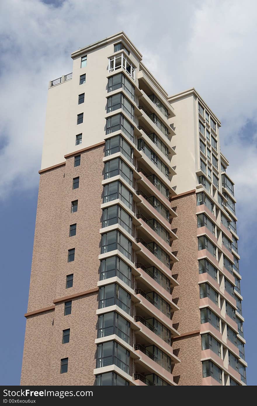 Apartment building under cloudscape in summer times