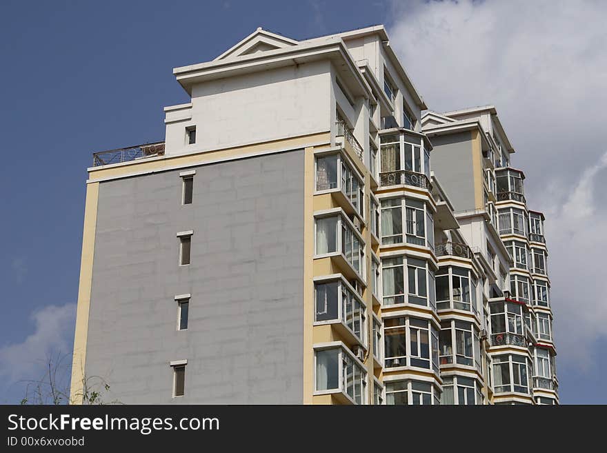 Apartment building under cloudscape in summer times