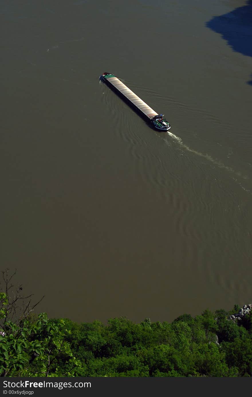 Commercial Ship flowing down the Danube river at Cazanele Mari gorge. Commercial Ship flowing down the Danube river at Cazanele Mari gorge