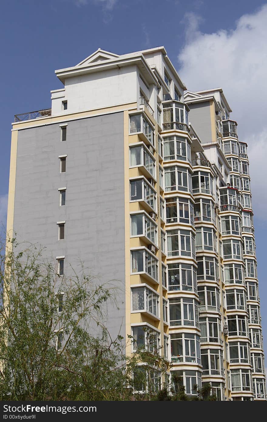 Apartment building under cloudscape in summer times