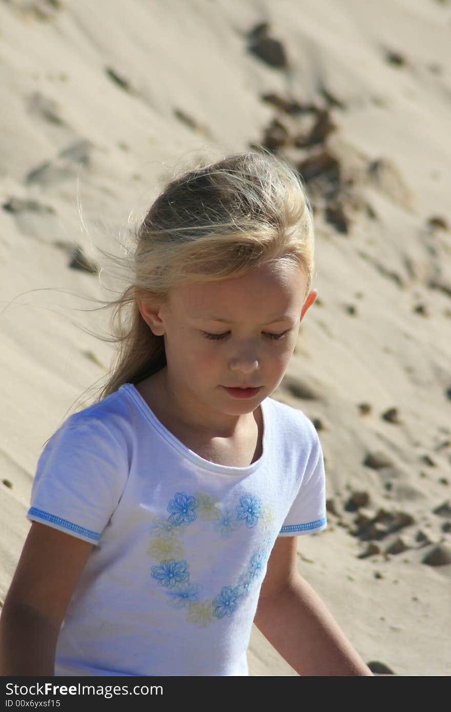 A beautiful white caucasian girl child with a sad expression on her face. A beautiful white caucasian girl child with a sad expression on her face