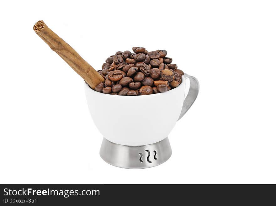 Cup, coffee beans and cinnamon stick