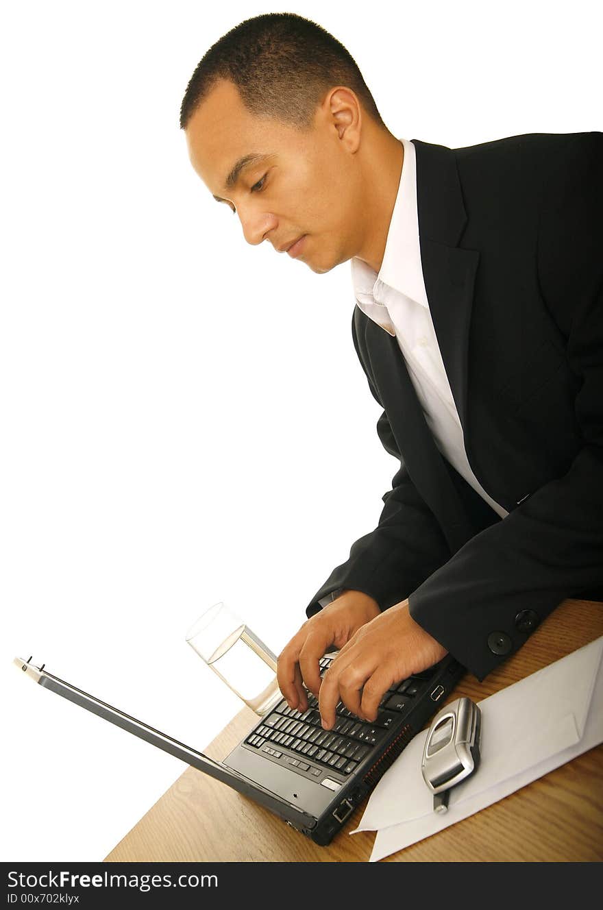 Isolated shot of handsome business man seriously working with his laptop. Isolated shot of handsome business man seriously working with his laptop