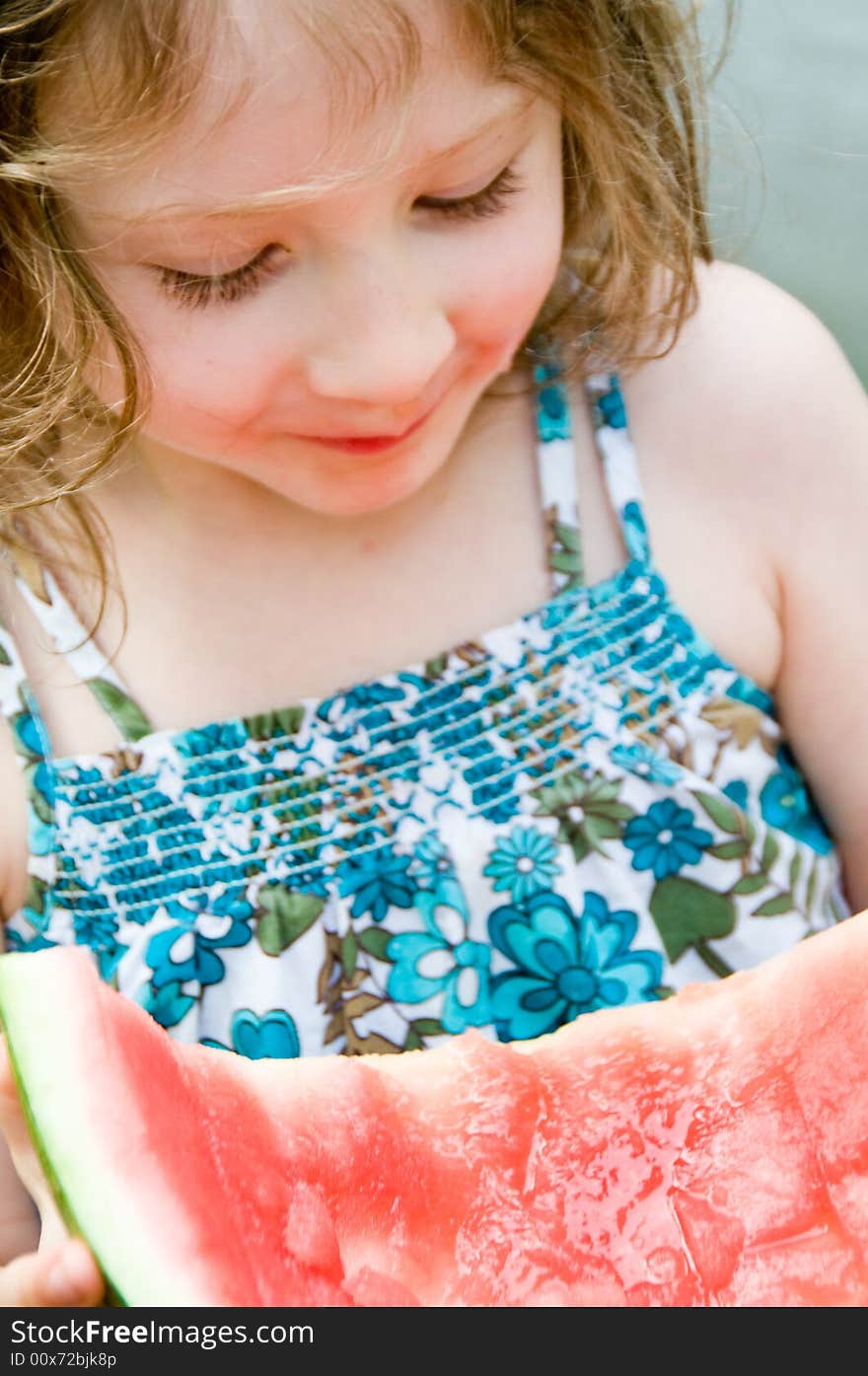 Pretty girl enjoys a tasty slice of watermelon