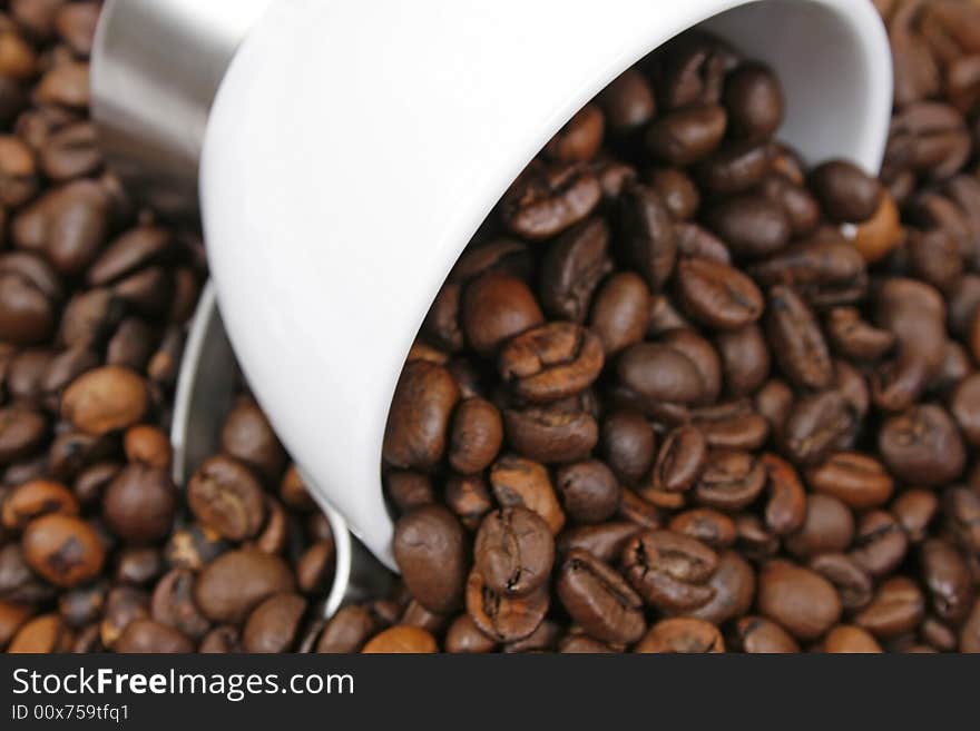 Coffee beans and white cup closeup