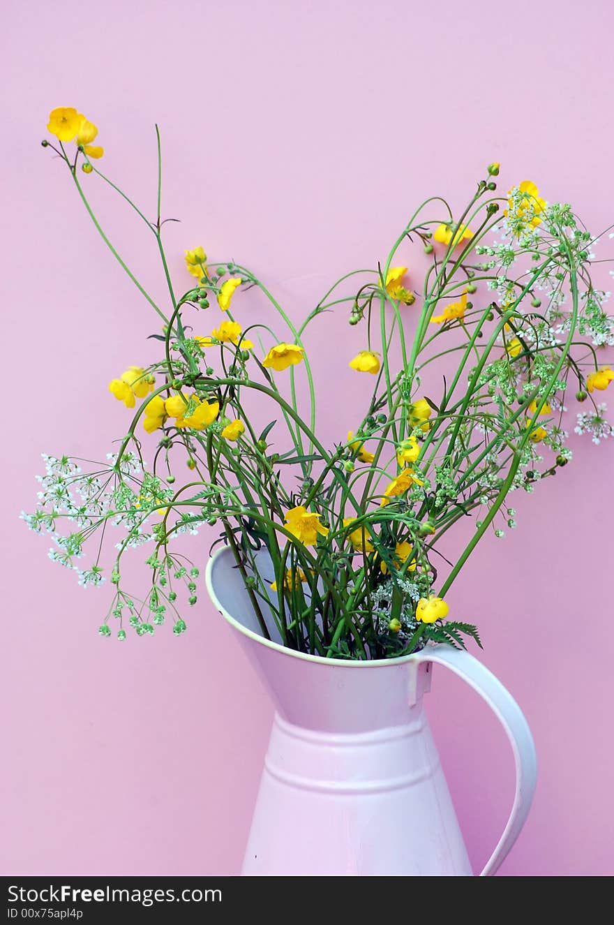 Hand picked wild flowers from the meadow,in a pink enamel jug