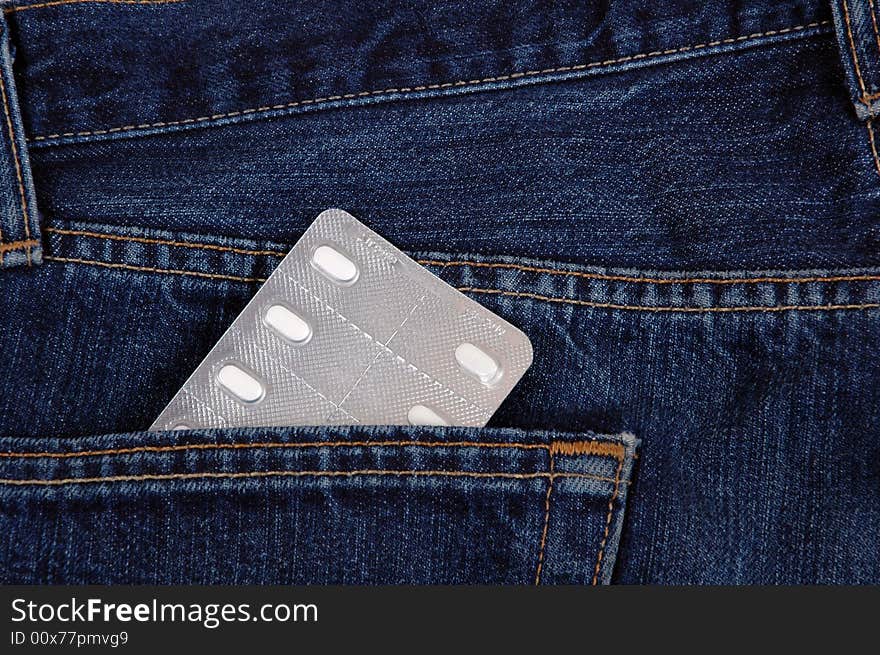 Tablets in the pocket of denim trousers. Tablets in the pocket of denim trousers.