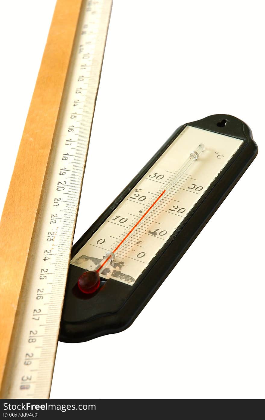 Old alcohol thermometer with Celsius scale and old wooden ruler in isolated background. Old alcohol thermometer with Celsius scale and old wooden ruler in isolated background.