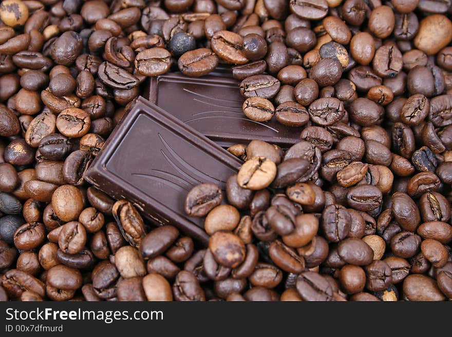 Chocolate on coffee beans background