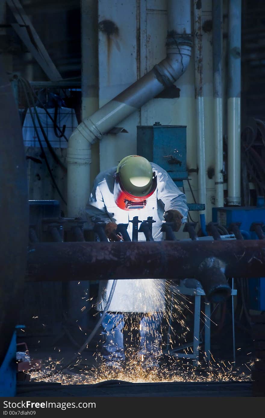 Male welder focused on job at factory