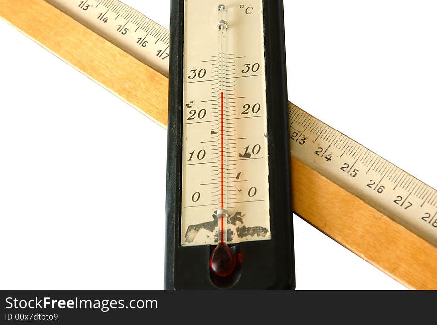 Old alcohol thermometer with Celsius scale and old wooden ruler in isolated background. Old alcohol thermometer with Celsius scale and old wooden ruler in isolated background.