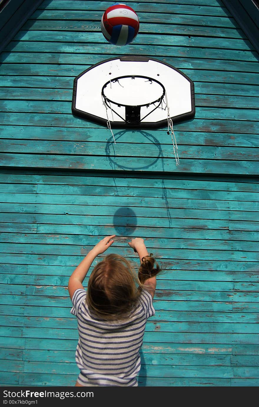 Girl trying to throw a ball in the basket. Girl trying to throw a ball in the basket