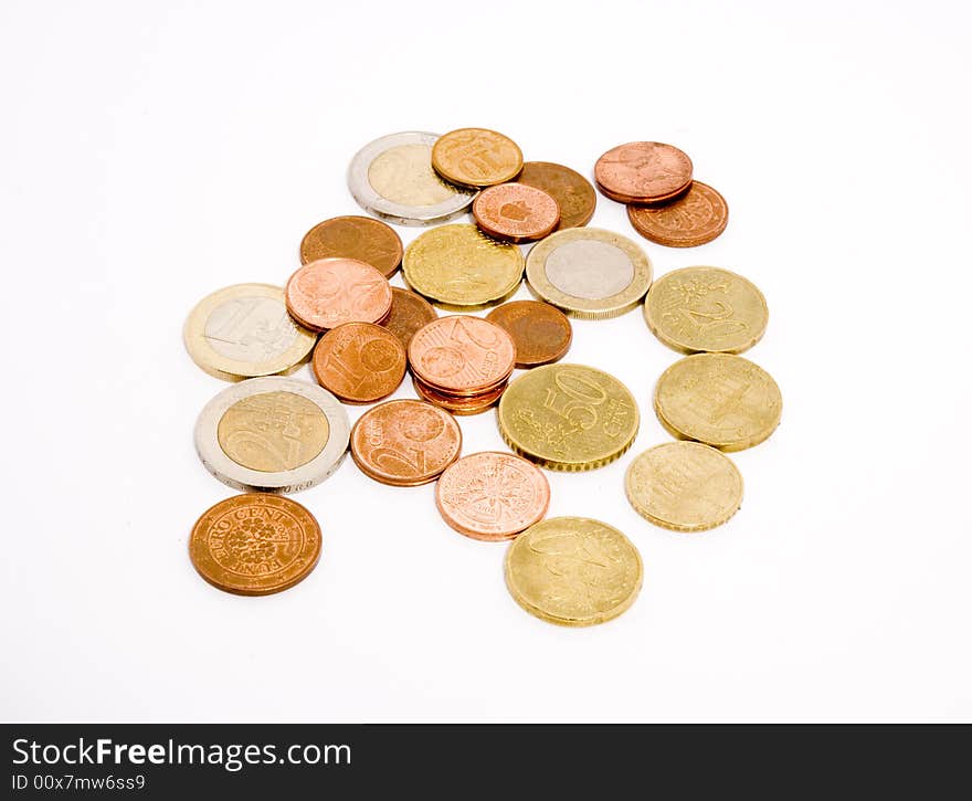 Different coins arranged unsorted over a white background. Different coins arranged unsorted over a white background