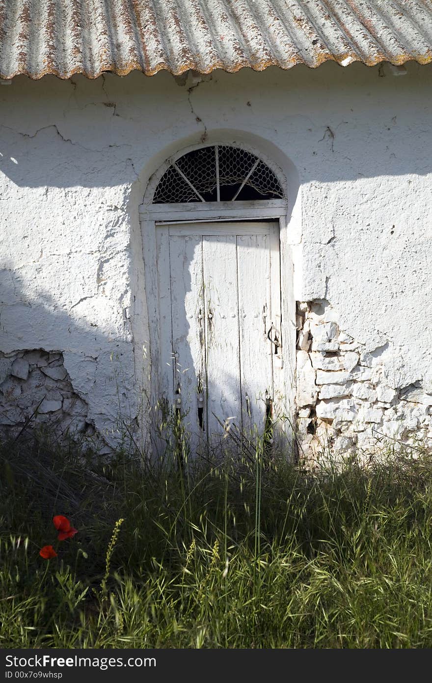 White wood door of a small house in the countryside. White wood door of a small house in the countryside