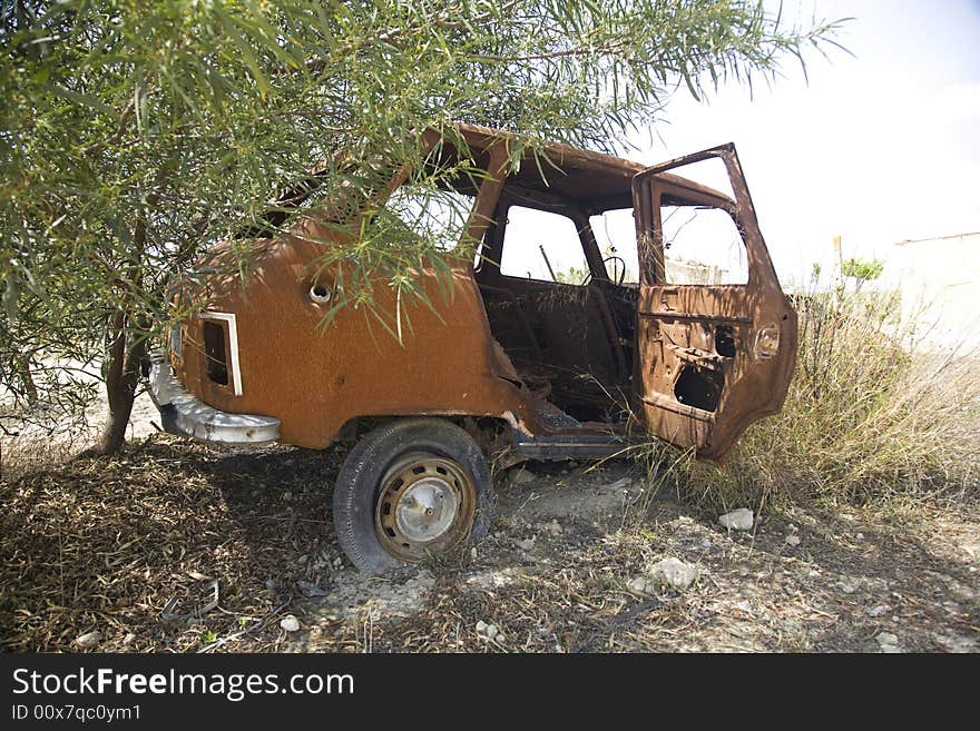 Dilapidated and rusty old car at the country. Dilapidated and rusty old car at the country