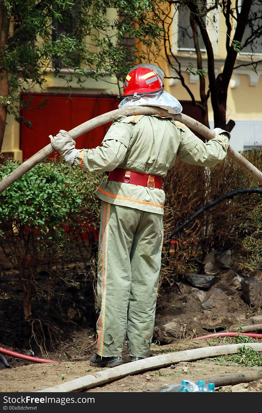 Fireman in action holding a hose