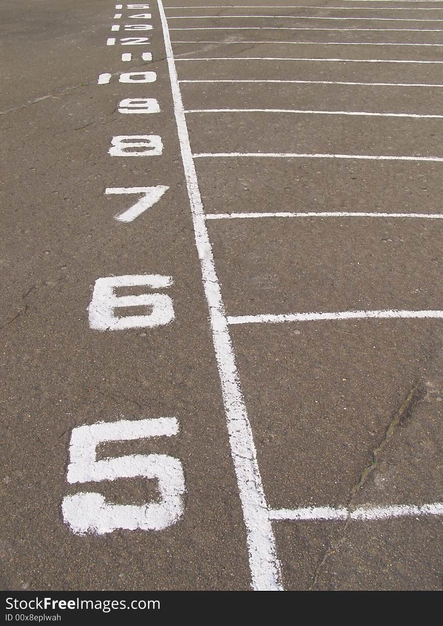 Dividing number painted on asphalt on stadium