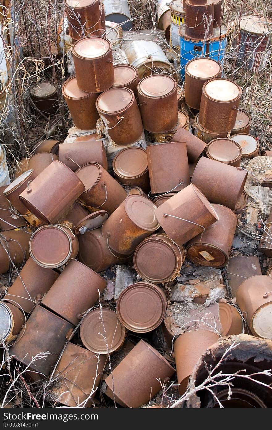 A large collection a oil based paint containers left in a field to leach into the ground. A large collection a oil based paint containers left in a field to leach into the ground.