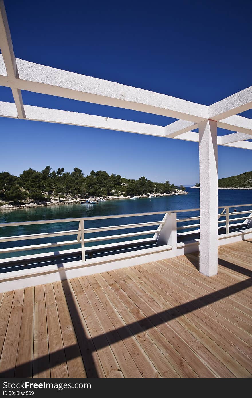 Metal structure to hold a roof build on a wooden deck next to the sea. Metal structure to hold a roof build on a wooden deck next to the sea.