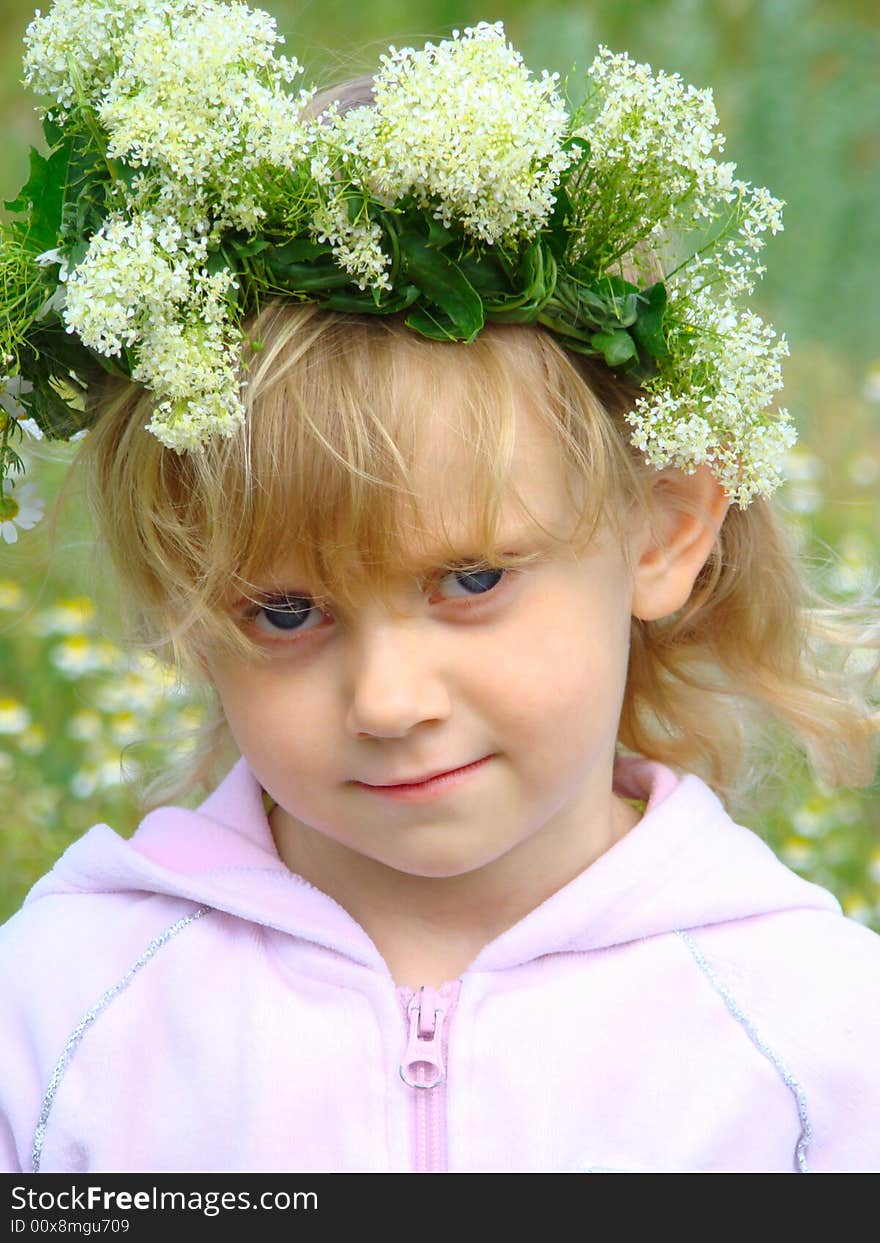 Nice little girl with a chaplet on the head. Nice little girl with a chaplet on the head.