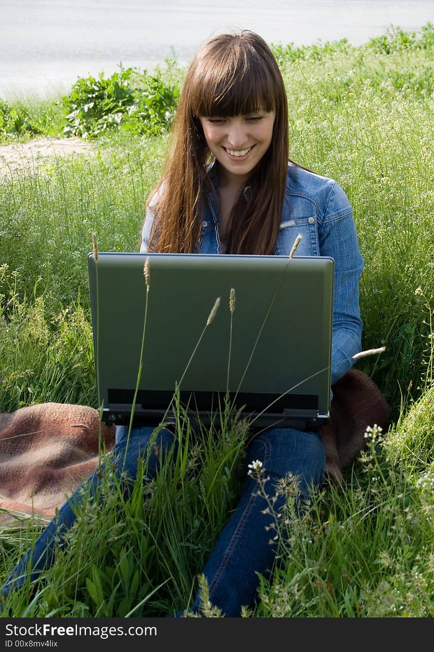 Happy girl with laptop outdoor