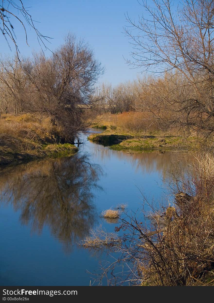 The still Poudre river as the banks begin to show signs of Spring. The still Poudre river as the banks begin to show signs of Spring