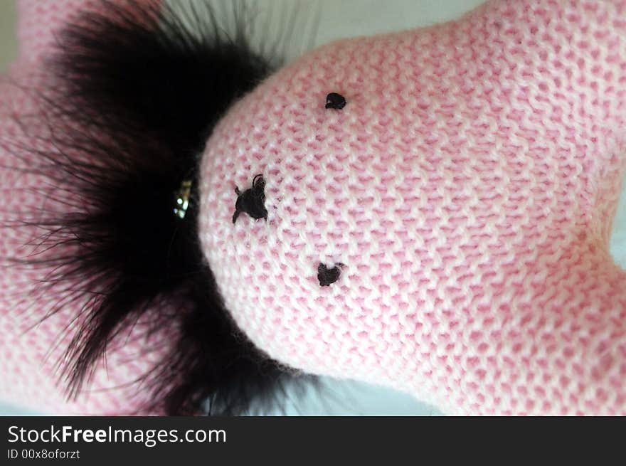 Pink hand-knit bunny in black feather. Pink hand-knit bunny in black feather