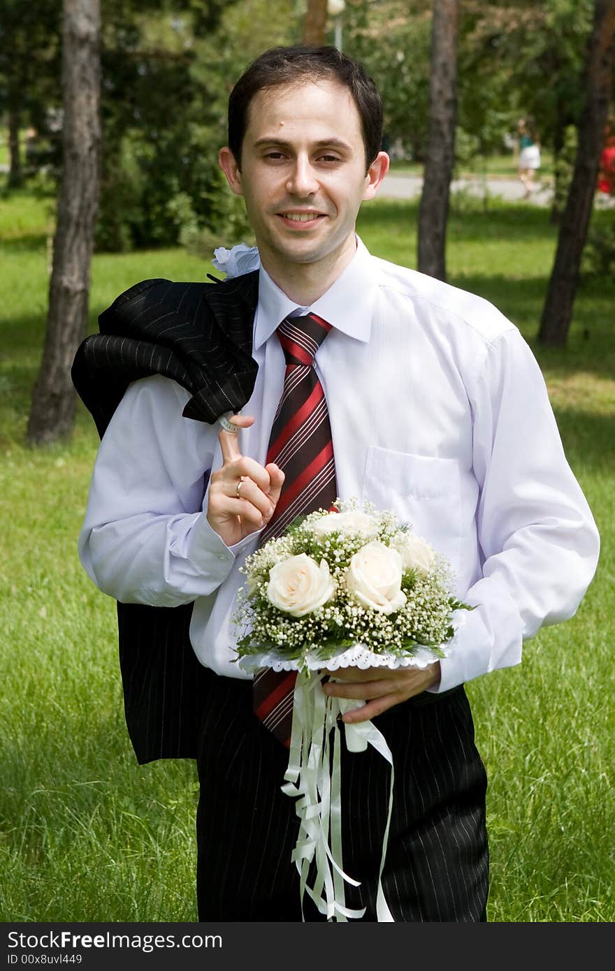 Well-dressed groom with rose bouquet. Well-dressed groom with rose bouquet