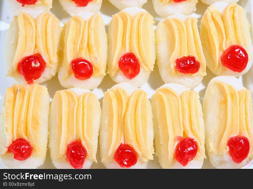 delicious indian sweets in a yellow and white long shape