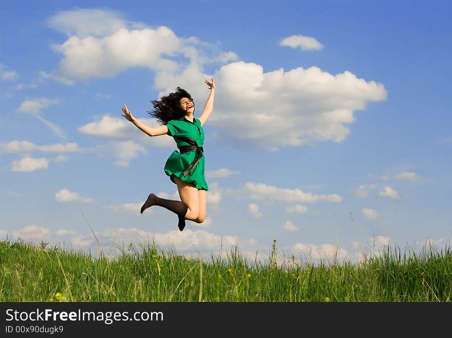 Happy young woman is jumping