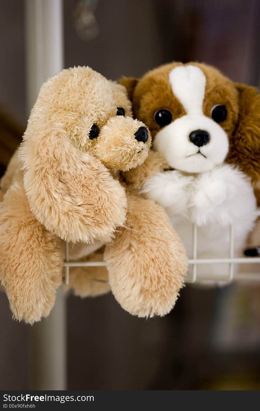 Two stuffed puppy toys in holding basket. Two stuffed puppy toys in holding basket