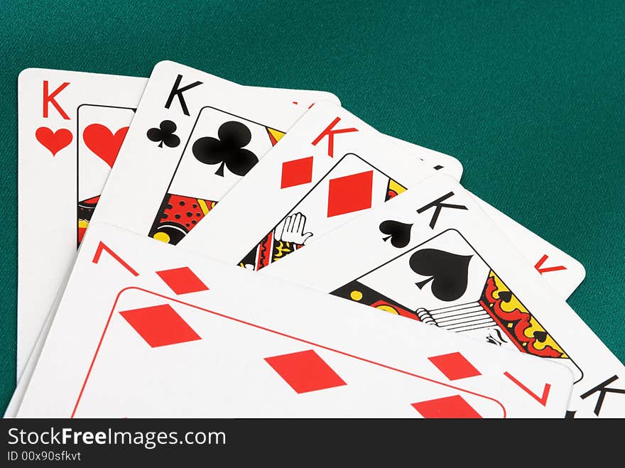 Playing cards close up on green fabric background