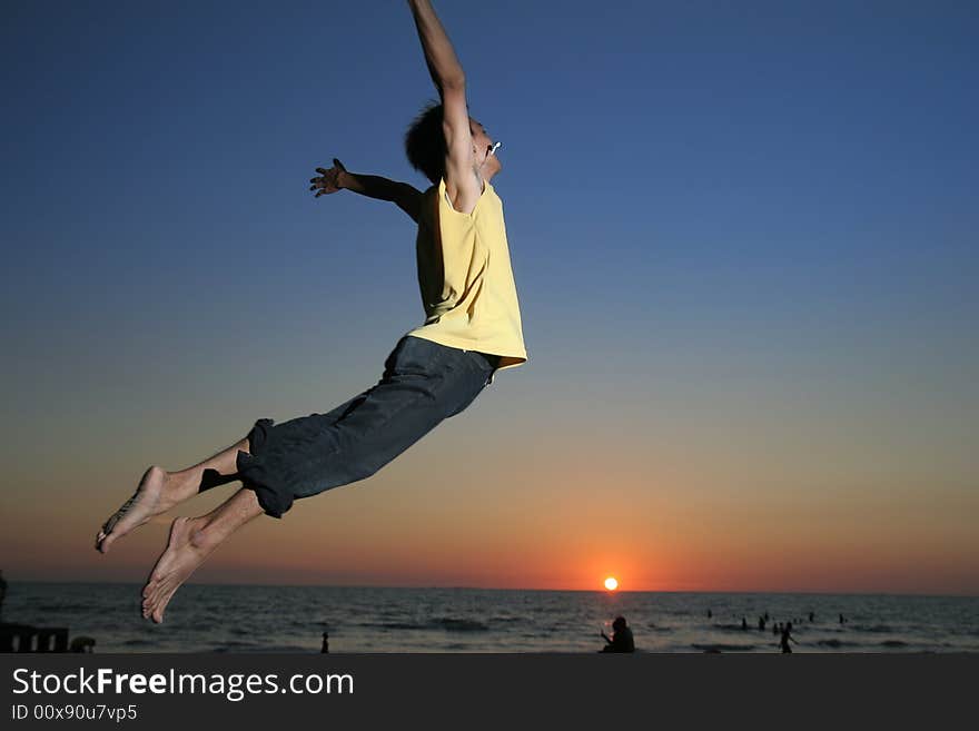 Jumping in the tropical sunset. Jumping in the tropical sunset