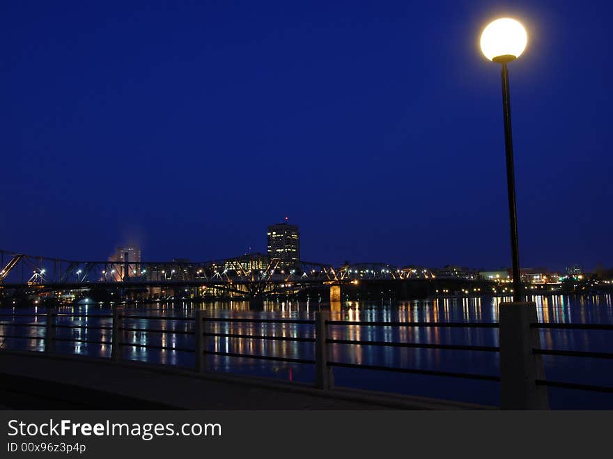 A lamp post lights up the sidewalk along the Ottawa River.  The smoke on the left is coming from the Scott Paper plant. A lamp post lights up the sidewalk along the Ottawa River.  The smoke on the left is coming from the Scott Paper plant.