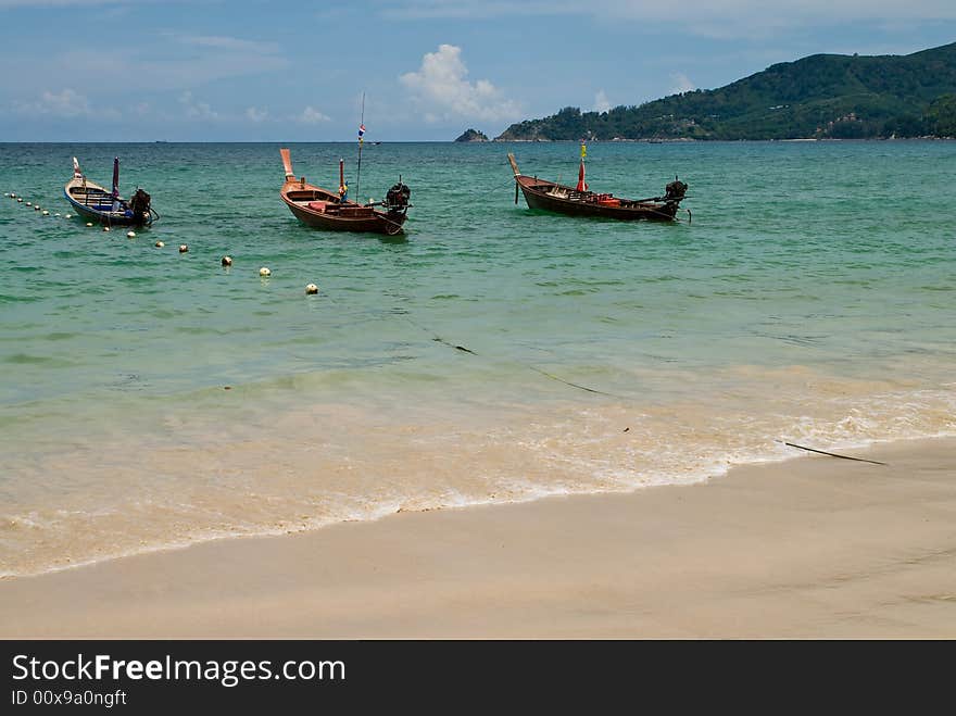 Three wooden boats at Patong beach, Phuket, Thailand