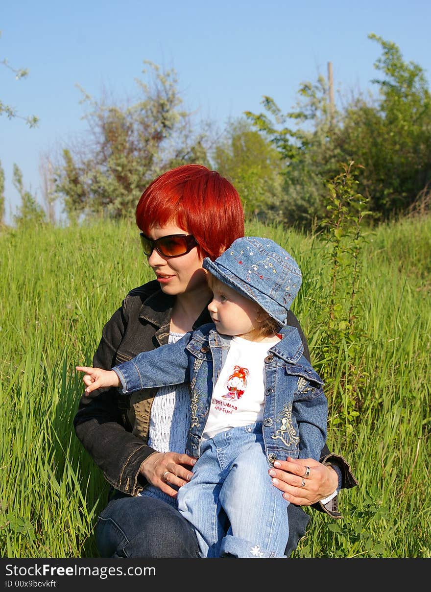 The little girl and her mum on a grass