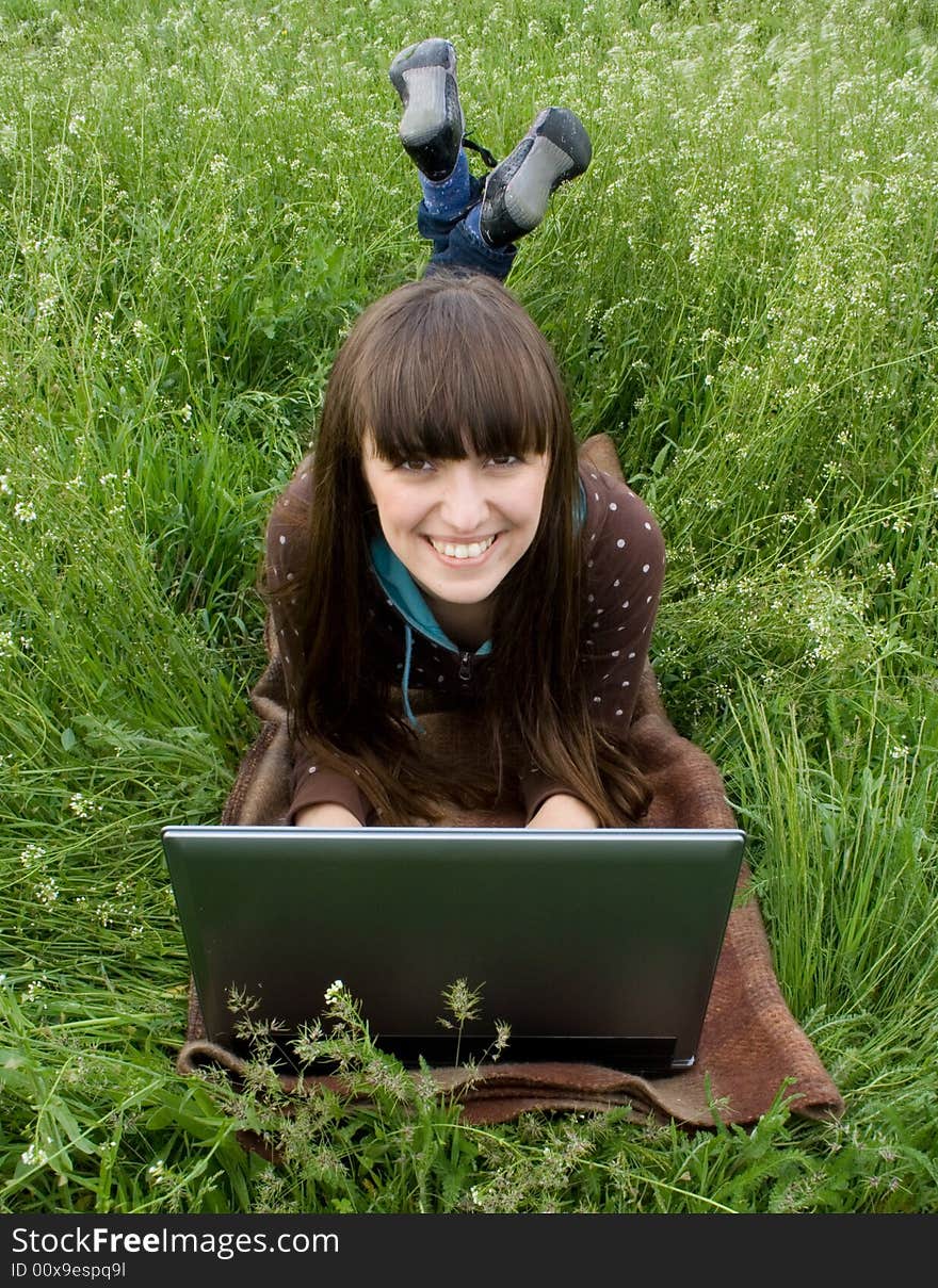 Happy girl with laptop outdoor