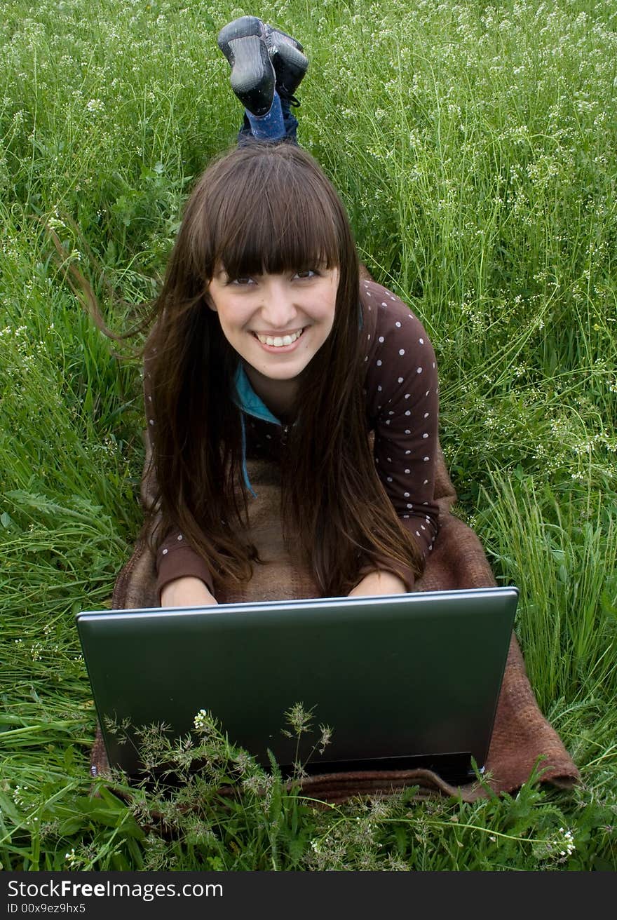 Happy girl working on laptop outdoor. Happy girl working on laptop outdoor