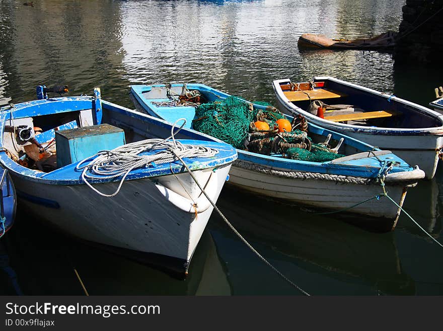 Old cog fishing boats white and blue, with fishing net, Cornwell, England