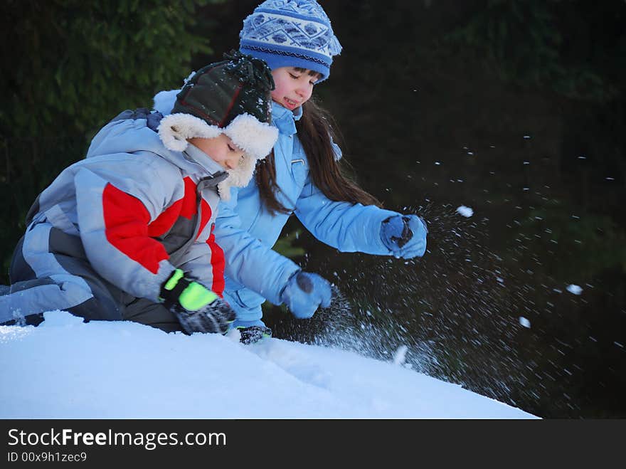 Siblings playing in snow