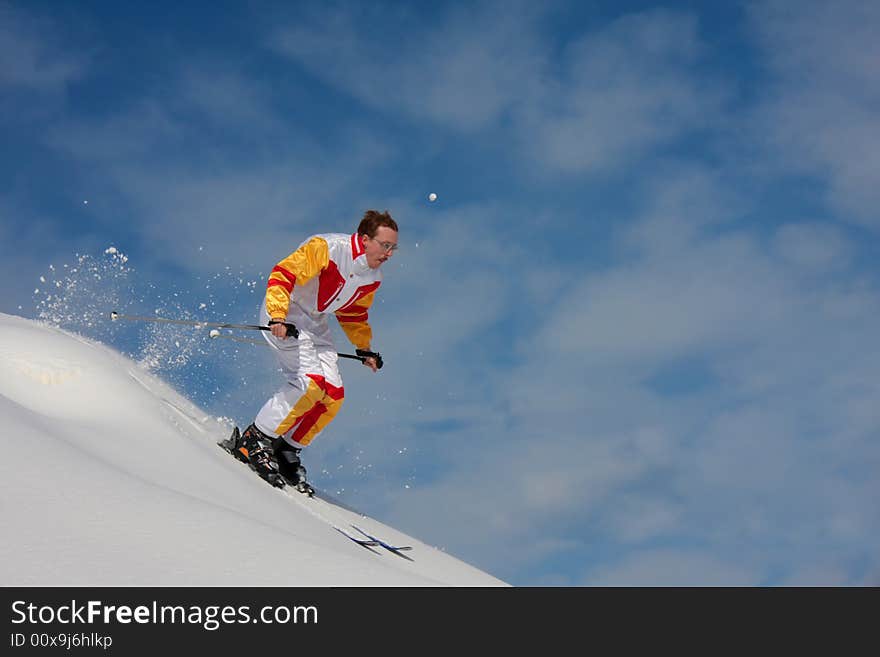 Bright winter day. The mountain skier moves down downhill. Bright winter day. The mountain skier moves down downhill.