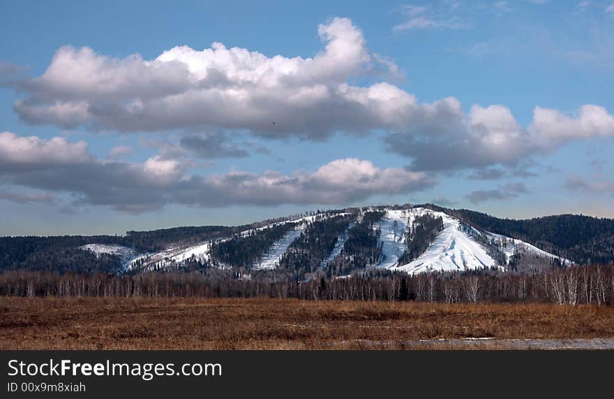 There is spring morning. The snow was kept only on northern slope of mountain. There is spring morning. The snow was kept only on northern slope of mountain.