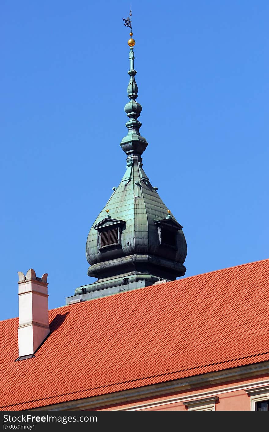 Pinnacle and roof of the Royal Palace in Warsaw. Clear blue sky.