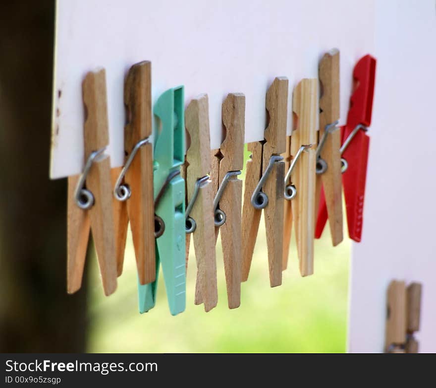 Multi-coloured clothespins weighing on a cord one after another