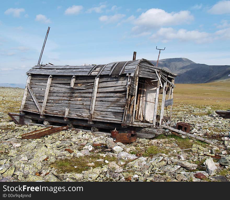 Photo. The old, abandoned wooden wagon in the mountains. Home.