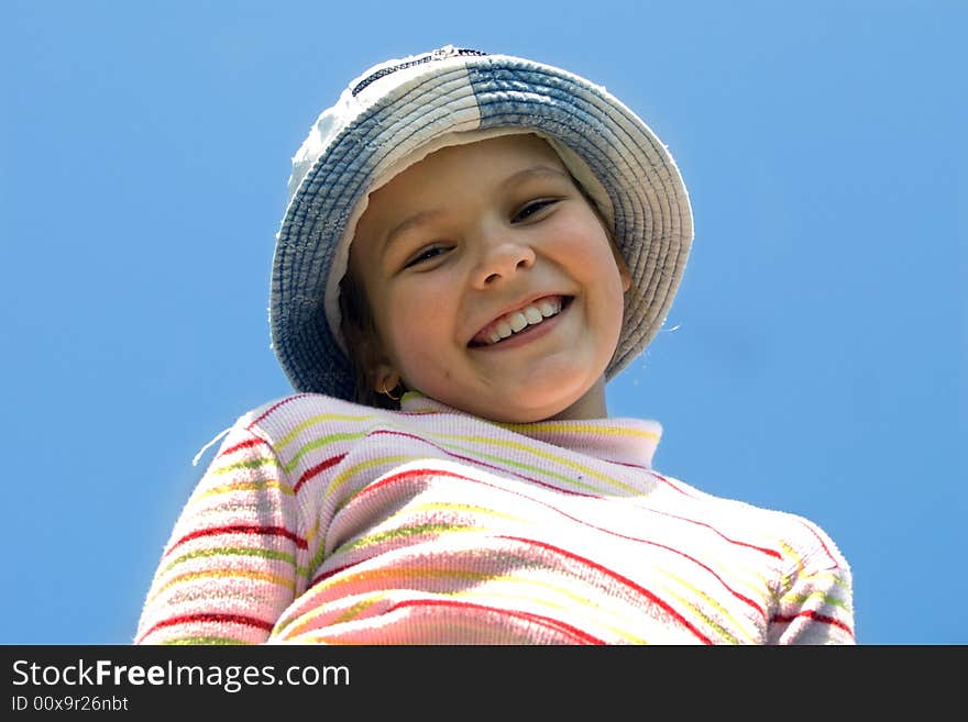 The young girl smiles against the sky. The young girl smiles against the sky